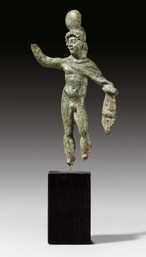 SMALL DIOSCURI STATUETTE,2nd century, found in Anatolia. Corroded bronze. On a wooden base. Feet and hands missing. H 6.8 cm. With expertise from the Galerie Arete, Zurich, 24 October 1974.