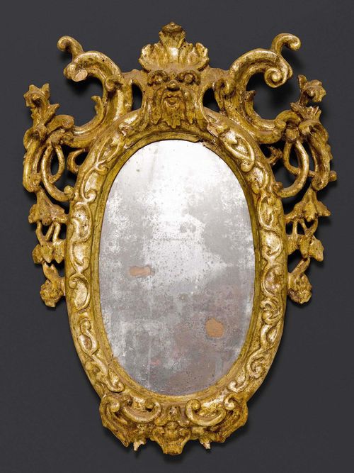 OVAL MIRROR,Baroque, Veneto circa 1700. Carved and silvered wood. H 38 cm, W 28 cm.