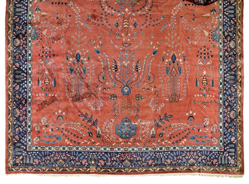 AGRA CARPET antique. Rust-red central field, patterned throughout with plant motifs in blue and white, blue border, signs of wear, tear to be restored, 430x670 cm.
