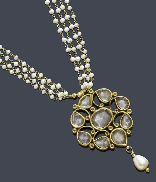 AN INDIAN PEARL AND ROCK QUARTZ NECKLACE. Decorative cluster pendant set with different rose-cut rock quartz and 16 small rubies ending with 1 freshwater cultured pearl suspension. Mounted on a delicate four-row necklace with numerous small pearls. L ca. 40 cm.