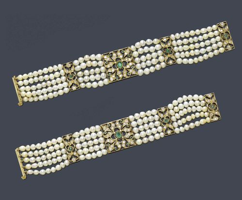 A PAIR OF INDIAN NATURAL PEARL, DIAMOND AND EMERALD BRACELETS, circa 1940. A pair of five-row bracelets with 135 baroque natural pearls and 5 cultured pearls, respectively 124 baroque natural pearls and 1 cultured pearl. The quadrangular pierced top set with 18 emeralds, 24 old European-cut diamonds and 3 matching barrette-shaped spacers set with 3 emeralds and 18 old European-cut diamonds in total. Total weight of the diamonds ca. 3.00 ct., total weight of the emeralds ca. 1.50 ct. L ca. 17,5 cm, and 16,5 cm.