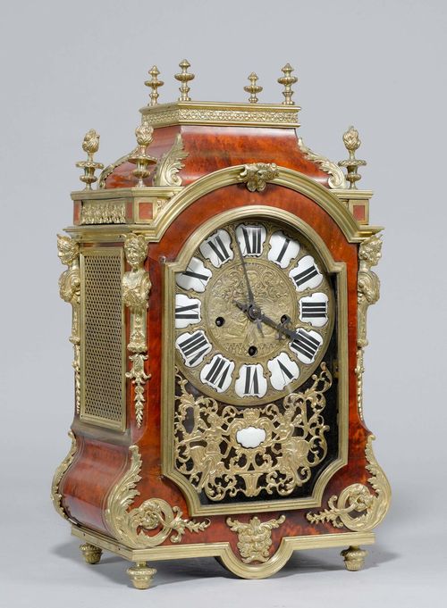 A MANTEL CLOCK, Louis XIV style, France circa 1900. Wood with red tortoise shell and rich bronze mounts. Bronze dial with relief decoration and white enamel cartouches. Movement with anchor escapement striking on 4 gongs. H 58 cm. Keys lost.