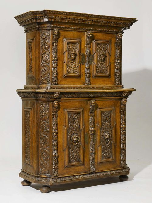 DEUX-CORPS CABINET, late Renaissance, France, 19th century. Richly carved oak. The recessed upper section with double doors. The lower section with drawer above double doors. Iron mounts. 130x59x185 cm.
