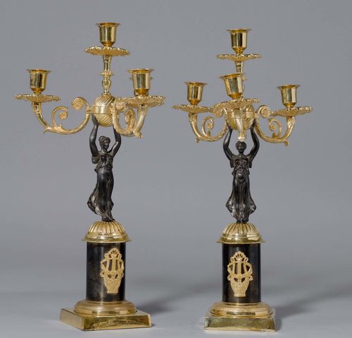 PAIR OF SMALL GIRANDOLES,Empire style, France. Gilt bronze and bronzed. Four-armed candle holder on a shaft designed as the Goddess of Victory. On a cylindrical base. H 41 cm.