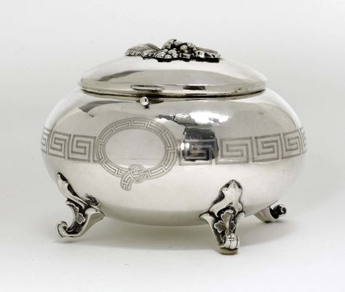 BOX WITH COVER,Austria, 19th century. With maker's mark: DF. Egg-shaped body with engraved band.  On 4 scroll feet. H 11,5 cm, 241 g.