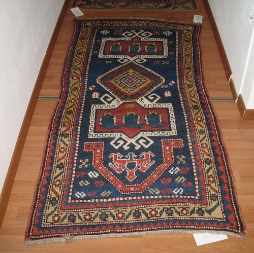 GENDJE old.Dark blue ground with an elongated medallion, geometrically patterned, yellow border, good condition, 80x160 cm.