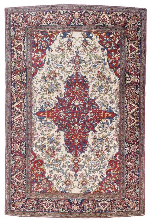 ISFAHAN antique.Beige central field with a red central medallion, finely patterned with trailing flowers in blue and green, dark blue border, good condition, 220x145 cm.