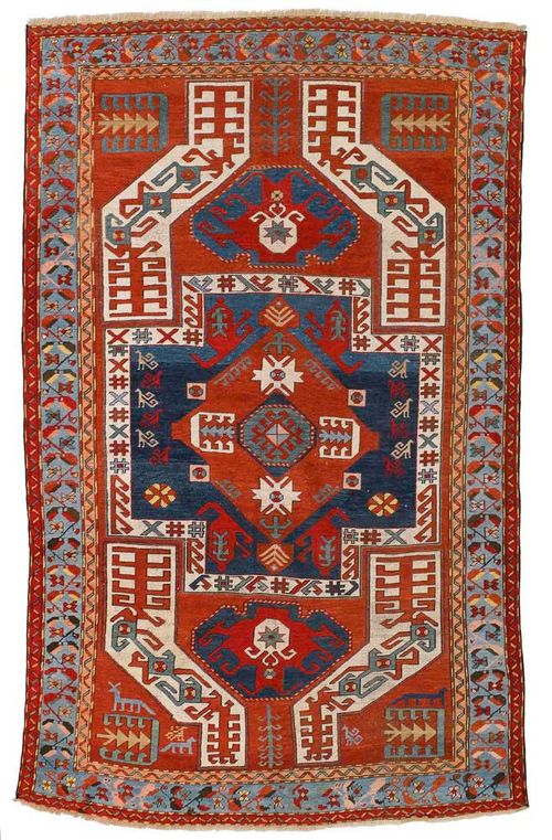 KAZAK old.Rust coloured ground with a blue central medallion and white corner ornaments, the entire carpet is geometrically patterned, light-blue border, restored, otherwise in good condition, 275x165 cm.