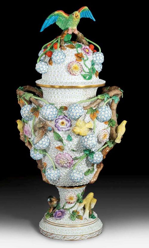 LARGE 'SNOW-BALL VASE' WITH LID, Dresden, 19th century. After a Meissen model by J.J.Kändler. Applied on all sides with flowers and snowballs. Underglaze blue sword with star, incised mark. H 81cm. Small chips and restorations. Provenance: from a Swiss private collection