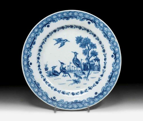 PLATE DECORATED WITH CRANES, Fürstenberg, circa 1770.Painted by Johann C.Kind-Voigt in underglaze blue with three cranes in a landscape. Lattice border and interwoven foliate work. Factory mark F and painter's mark K for J.C. Kind in underglaze blue. D 23.3cm. Small flat chip to the edge. Provenance: -Dr. Andreina Torre, Zurich. -Private collection, St.Gallen.