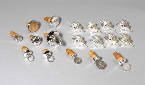 8 SKEWER TONGS AND 10 BOTTLE STOPPERS,in part marked. Associated, different decorations.