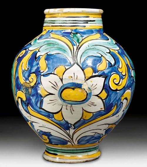 MAIOLICA APOTHECARY JAR, Sicily, Caltagirone, 17th century. Decorated in green and ochre yellow acanthus leaves on a blue ground. H 26.5cm. The edge of the foot chipped. The glaze flanked, and with a visible repair to the side. Firing pontil