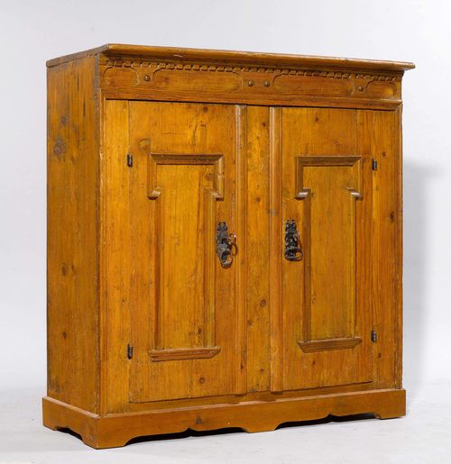 HALF-HEIGHT CABINET,Baroque, from the Alpine region, probably Grisons or Tyrol. Pinewood. Rectangular body on a later, carved plinth. Front with 2 doors. Iron mounts. 117x48x123 cm. 2 keys. Later back wall, with alterations.