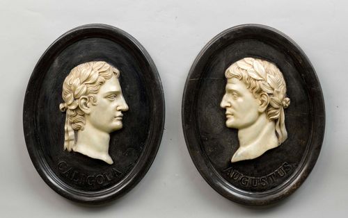 PAIR OF MARBLE RELIEFS, Italian, after designs from Antiquity. Oval. Heads in profile, depicting the Emperors Caligula and Augustus. 48 x 37 cm.