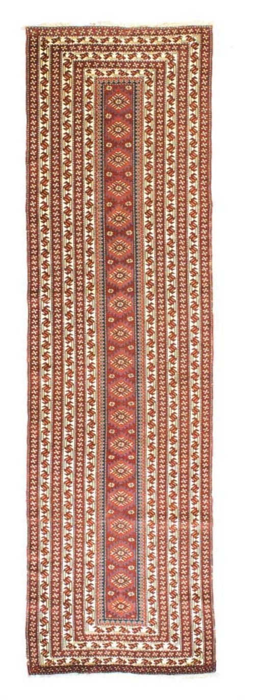 GENDJE RUNNER antique.Narrow, rust coloured central field with star motifs, wide border in brown and white with stylised tendrils, good condition, 314x83 cm.