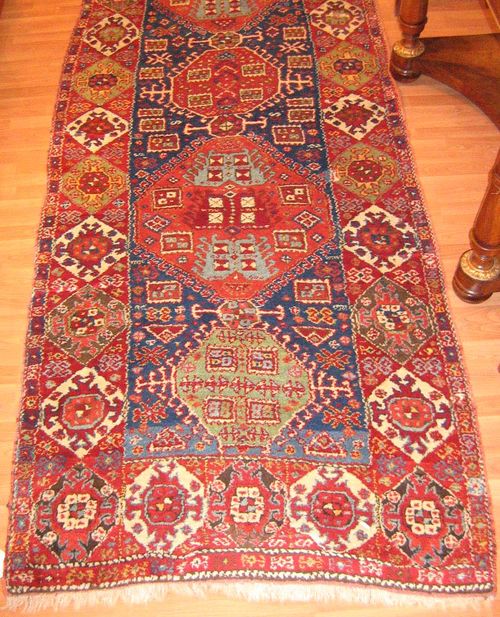 KURDISH antique.Blue central field with four medallions, geometrically patterned, red border, restored, 355x135 cm.
