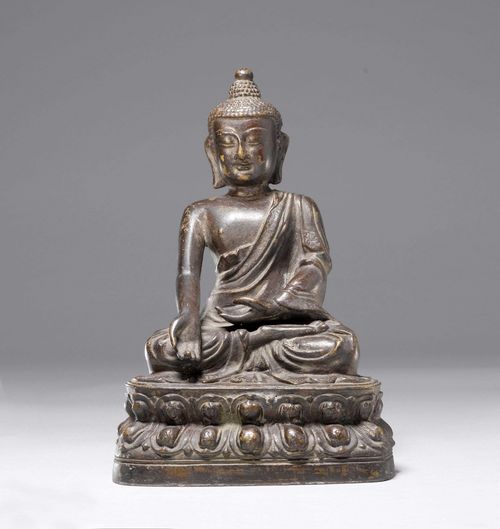 A DARK PATINATED BRONZE FIGURE OF BUDDHA SEATED. China, Ming Dynasty, Height 27.5 cm. Consecration plate added.