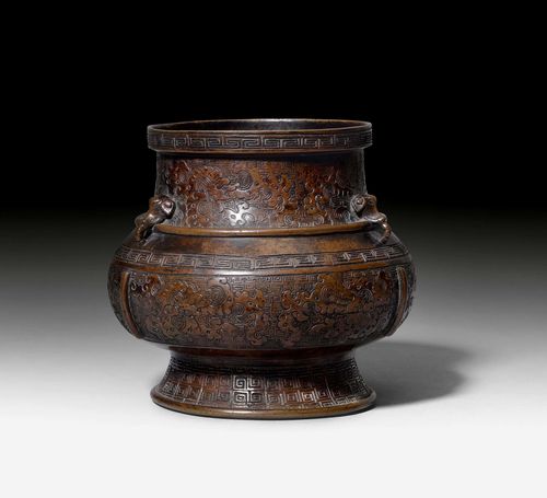 A PATINATED BRONZE CENSER ON A HIGH FOOT WITH ELEPHANT HEAD HANDLES AND MYTHICAL BEASTS ON A LEIWEN GROUND. China, 19th c. Height 15.3 cm.