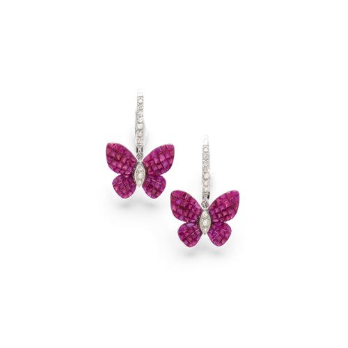 RUBY AND DIAMOND EARRINGS. White gold 750. Each with 1 removable pendant designed as a butterfly, the wings set throughout with square-cut rubies, invisible setting, total weight of the rubies ca. 8.90 ct, the body additionally set with 4 brilliant-cut diamonds. Total diamond weight ca. 0.20 ct.