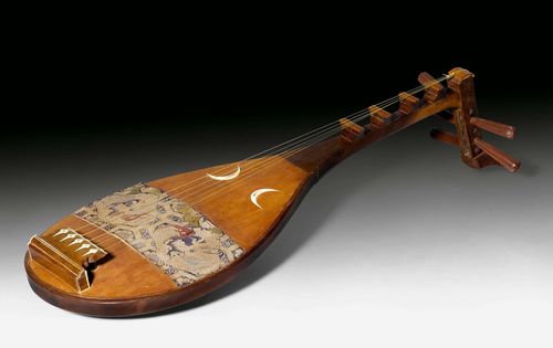 A WOODEN BIWA INSTRUMENT WITH IVORY DETAILS AND PROTECTIVE CLOTH WITH A BROCADED GOLDEN DRAGON ON A BLUE GROUND. Japan, Length 90 cm. Minor damage.