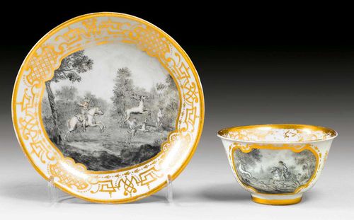 FINE CUP AND SAUCER WITH AUGSBURG HAUSMALER DECORATION, Meissen, circa 1725.The painting Augsburg, probably by the workshop of Sabine Aufenwerth. Painted in schwarzlot in style of J.E. Ridinger. Gold border. Potter's mark/, remains a gold mark SL on the saucer. Gilding slightly rubbed.