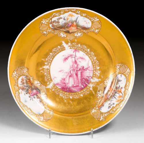 PLATE WITH WATTEAU SCENES AND GOLD BACKGROUND, Meissen, circa 1740-45. Saucer for a tureen. The back with two flower branches and individual flowers. Underglaze blue sword mark, impressed number 16. D 23.4cm. Gilding slightly rubbed in the center. Provenance: - Private collection, Hamburg. - Private collection, South Germany. Exhibited: 'Meissener Porzellan des 18. Jahrhunderts aus Hamburger Privatbesitz', Museum für Kunst und Gewerbe Hamburg, June 4 - September 5, 1982. Illustration in catalog of the same title by Hermann Jedding, Hamburg 1982, p. 111, No. 99 and Ill. 112.