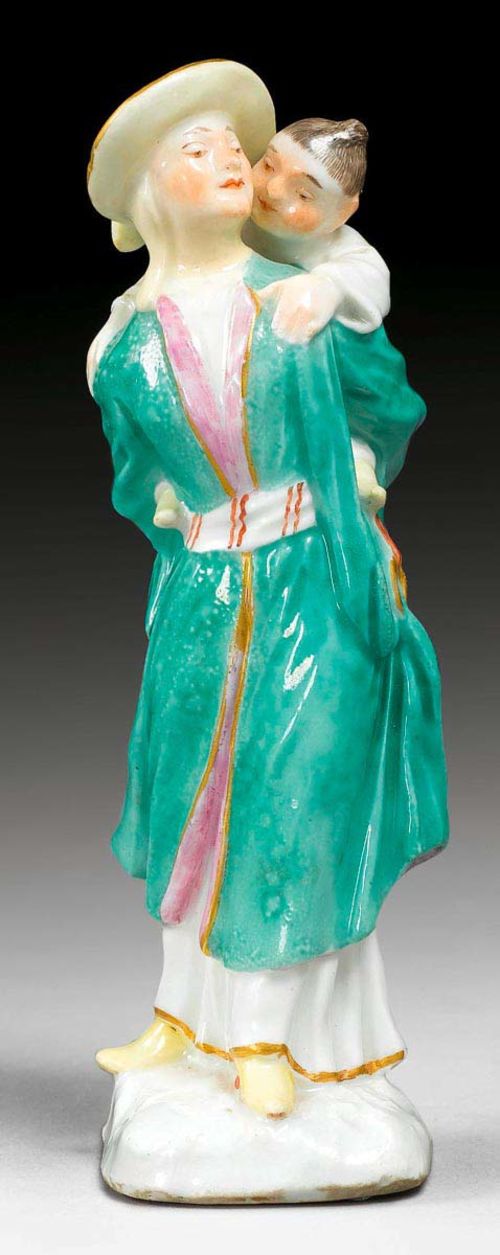 FIGURE OF CHINESE WOMAN WITH CHILD ON HER BACK, Meissen, mid 18th century. Underglaze blue sword mark on the back of the base. H 12.5cm.