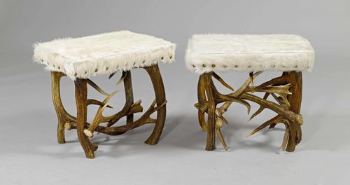 PAIR OF ANTLER STOOLS,in the style of the Alpine region. Rectangular, padded seat with a white fur cover.