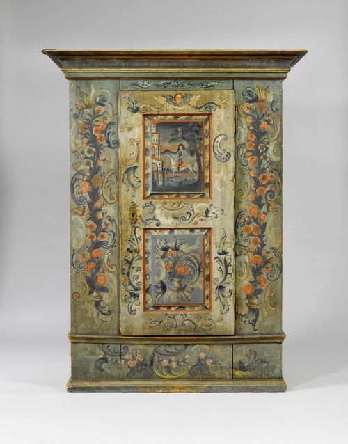 FROM THE DE AMODIO COLLECTION: PAINTED CUPBOARD,Toggenburg, dated 1785 and designated M. Roland ...cher und Anna Elisabetha Fischbacherin. Pinewood, opulently painted with trailing flowers, rocailles and the head of an angel on a green/blue ground. The door is double-panelled. The upper panel depicting a man on his horse, the lower panel depicting a pot with flowers. The sides painted with stylised rocailles. Brass escutcheon. 139x63x183 cm. 1 key. Rubbed in parts. Provenance: - Koller Auction, Zurich. - from the collection of the Marquise de Amodio y Moya.