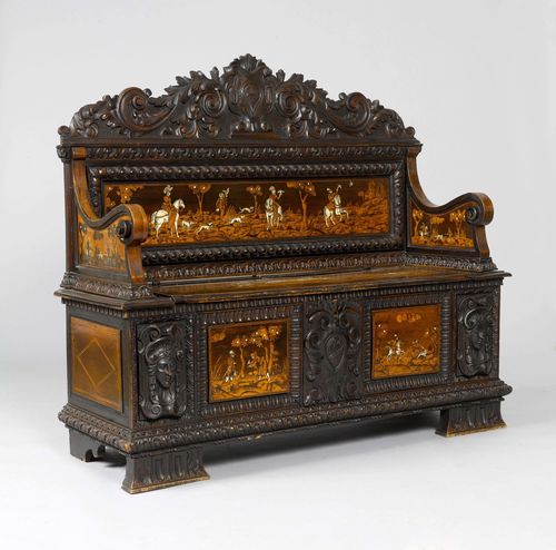 INLAID CASSAPANCA,Renaissance style, probably Italy, 19th century. Walnut, carved with leaf volutes, faces, cartouches, and ivory inlays depicting hunting scenes. Rectangular body with hinged cover. Top of backrest carved. L 152 cm. Some losses.