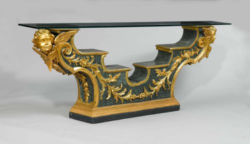 ALTAR RAIL AS A CONSOLE,late Baroque, Italy, 19th century. Carved wood, decorated with leaf garland and heads of angels, painted and parcel-gilt. With rectangular glass top. 234x31x88 cm. Some losses.