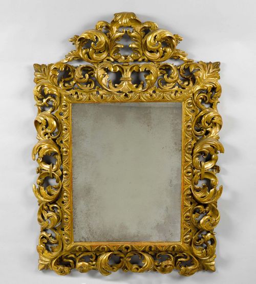 CARVED MIRROR,Baroque style, Italy, 19th century. Wood, carved and gilt. Rectangular frame with pierced leaf volute border and pierced top. H 158 cm. Some losses.