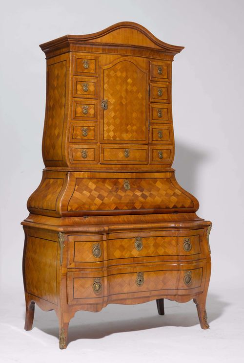 TABERNACLE WRITING COMMODE, Baroque, Germany, Main-Franconia, 18th century. Walnut inlaid with marquetry and dark fillets. The upper part with door and 11 drawers. Convex, hinged writing surface opening onto 2 compartments and 6 drawers. The lower part with a curved front and 2 drawers. Brass mounts, not original. 108x61(79)x195 cm. 4 keys. Restored, small losses in the veneer. Central lock deactivated. Inner veneer, not original.