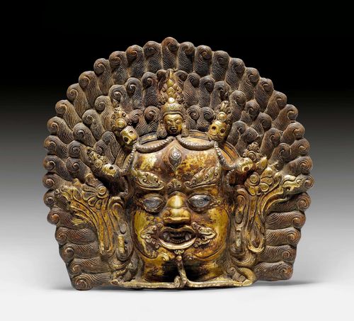 A GILT BRONZE MASK OF BHAIRAVA WITH SILVER INLAYS. Nepal, antique, height 16 cm.