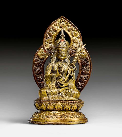 A BRONZE AND COPPER ALLOY FIGURE OF PADMASAMBHAVA WITH AUREOLE, SEATED  ON A REPOUSSÉ LOTUS THRONE. Nepal, 18th c., height 24 cm. Removable aureole.