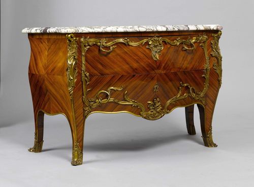 COMMODE,Louis XV style, France. Purpleheart. Trapezoid body, curved on three sides, with curved legs. Front with 2 sans traverse drawers. Opulent bronze mounts designed as leaves, volutes and rocailles. 146x65x92 cm. Light, grey veined marble top.