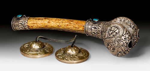 A PAIR OF METAL ALLOY CYMBALS JOINED WITH A LEATHER STRAP, AND A BONE TRUMPET WITH TERMINALS OF CHASED SILVER, SET WITH TURQUOISES. Tibet, antique. Cymbals: diameter of each 7 cm. Trumpet: length 30 cm. (2)