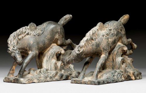 A PAIR OF STONE HORSES ON WAVES, PART OF A HOUSE OR TEMPLE. China, Ming dynasty, length 42 cm each. Tails repaired.