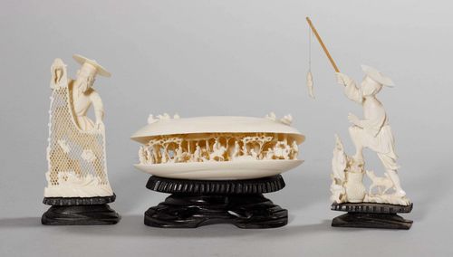 THREE IVORY CARVINGS. Japan, around 1960, lengths to 13.2 cm. a) Fisherman with fish. b) Fisherman with catch in an openwork net. c) Open shell revealing a garden scene. All with wooden bases. (3)