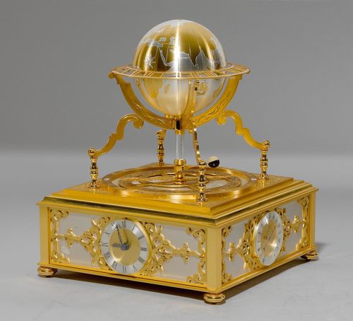 TABLE CLOCK WITH ASTROLABIUM AND GLOBE,Hour Lavigne, Paris, 20th century. Bronze, brass and white metal. Rectangular case with glass cloche. The base containing the clock movement, a thermometer, a barometer, and a hygrometer. Under the cloche, a globe with orbiting moon, and an astrolabium. Battery-operated. 25x25x34 cm. Glass cloche, slightly cracked.