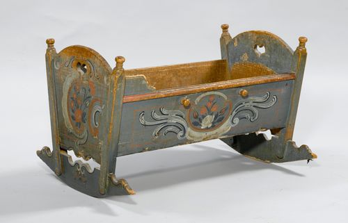 PAINTED CRIB,Appenzell or Toggenburg, end of the 18th century. Pinewood, painted with flowers and rocailles on a blue ground. Headboard and footboard of equal height. Straight side parts. 64x88x52 cm. Painting partly rubbed.