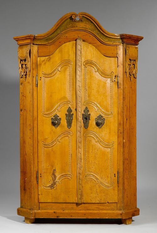 CUPBOARD,Transition, probably from the Salzburg region, Austria, ca. 1800. Pine and cherry, carved with rocailles and flowers. Rectangular body, the front with double-doors and bevelled corners. Metal mounts. 112x5x188 cm. 1 key.