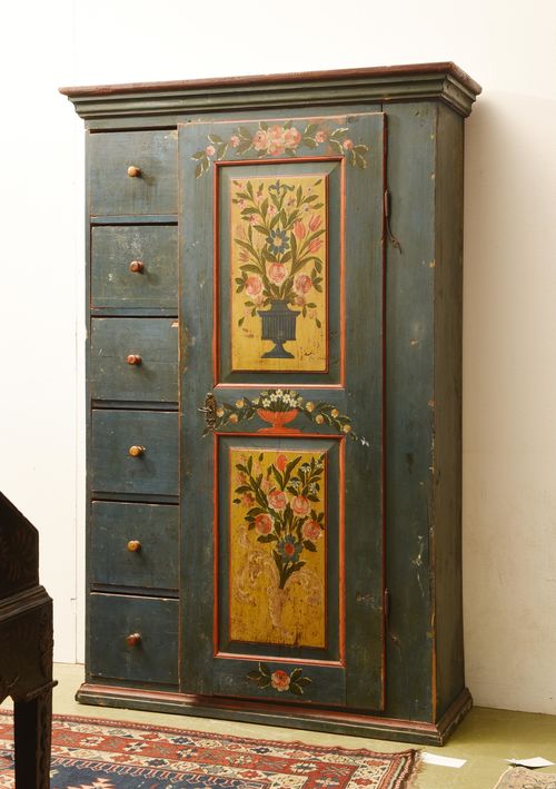PAINTED "SCHAFREITE" CUPBOARD,Southern Germany, Biedermeier, beginning of the 19th century. Pinewood, painted with bouquets of flowers, rocaille, a vase and garlands on a blue ground. Front with 6 drawers and a double-panelled door. Brass escutcheon. 117x37x183 cm. Some losses. 1 key.