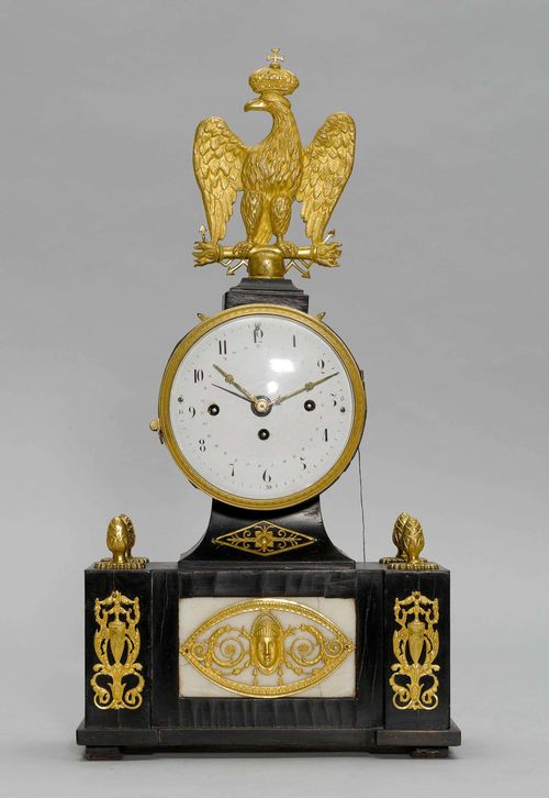 MANTLE CLOCK WITH DATE,Biedermeier, Vienna. Ebony and alabaster. White enamel dial (restored). Movement with anchor escapement and Grand-Sonnerie on 3 bells. Repetition on demand. H 46 cm.