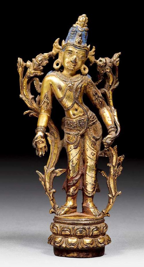 STANDING AVALOKITESHVARA.East India or Tibet, Pala style, 12th century. H 14 cm. Gilt copper alloy with blue painting in the hair.