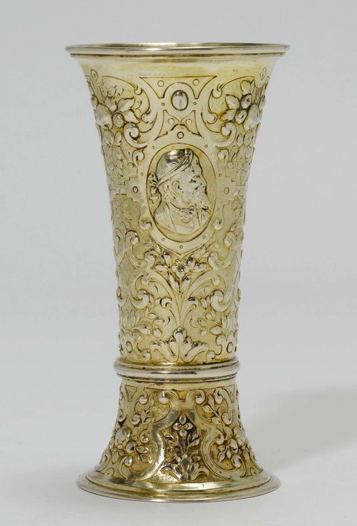 SILVER-GILT BEAKER,probably Germany, 19th century. Conical beaker with chased walls. Floral decoration and portraits in profile. Provenance: from a German private collection.