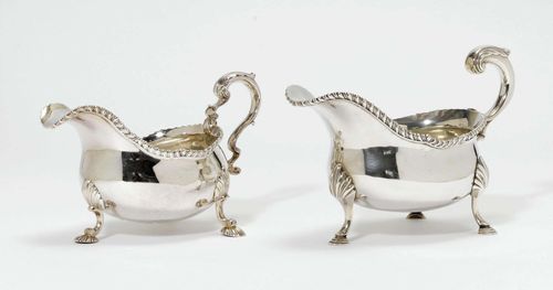 2 SAUCE BOATS,probably England, 19th century. Maker's mark GSWE and GM. Assorted. Smooth-walled vessels on three stepped feet. Large handle decorated with volutes and palmettes.