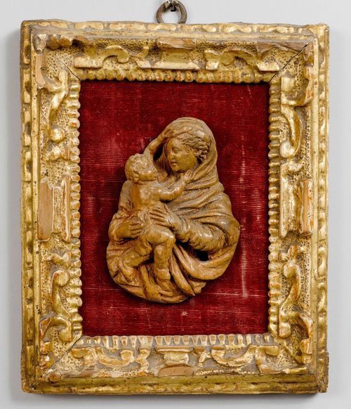 MADONNA AND CHILD,Baroque, probably Austria or Germany, beginning of the 18th century. Wood, carved in relief. Mary in profile, holding the Infant Jesus in her arms. H 8 cm. In a gilt frame. Formerly painted.