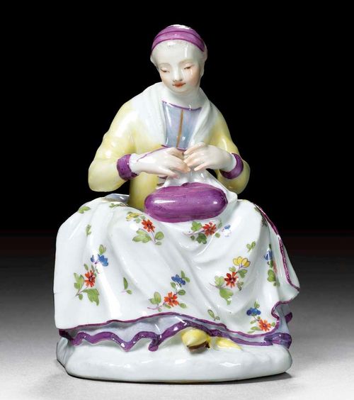 FIGURE OF A SEAMSTRESS, Meissen, circa 1746.Model by J.F.Eberlein. Underglaze blue sword mark verso. H 11.5cm. Provenance: from a Swiss private collection