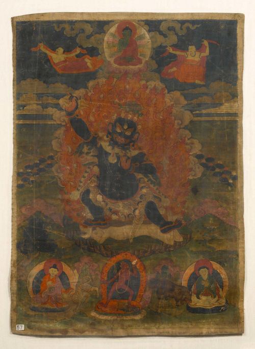 TANGKA OF CANDAVAJRAPANI. Tibet, 19th c. 66x47 cm. At centre the wrathful Candavajrapani stands within a flaming mandorla. Below are seen a Dakini and two Mahasiddhas. Amogasiddhi sits above, flanked by two apsaras. Mounted under glass.